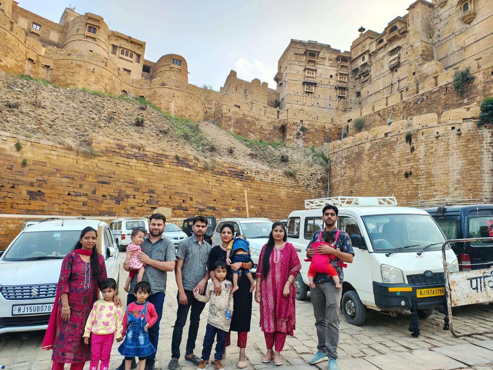 Family beside taxis below the fort walls